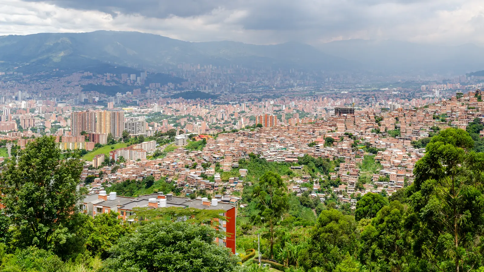 View over Medellín from the Robledo district towards the city centre, with mountains behind
